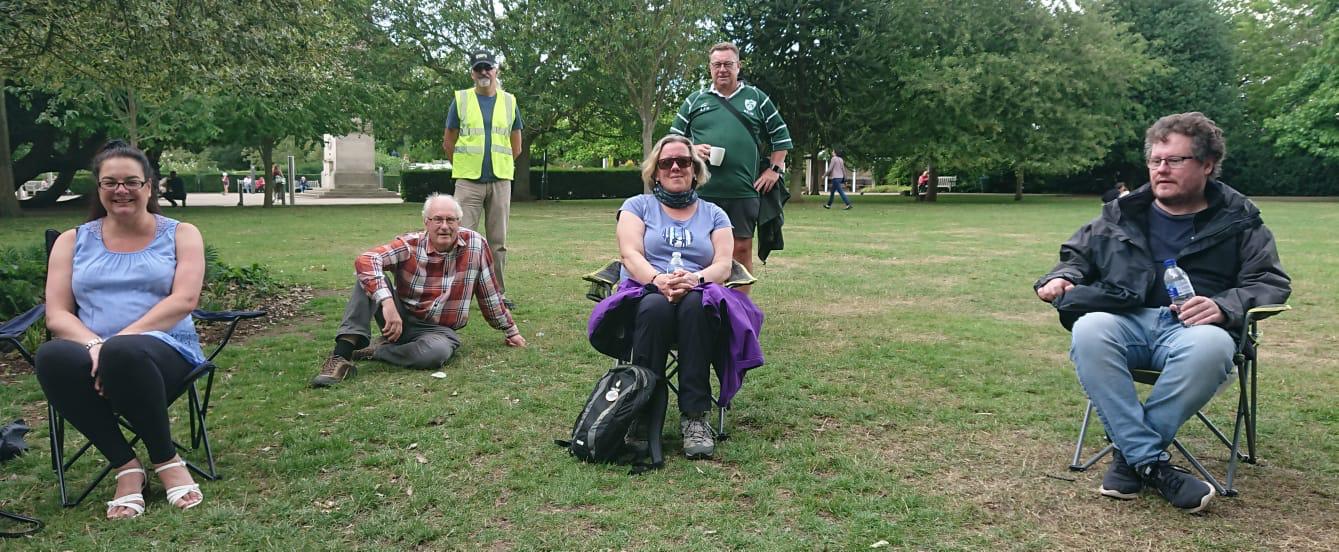 people in a park sat on chairs